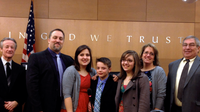 A family in court on their 10-year-old son's adoption day from foster care.