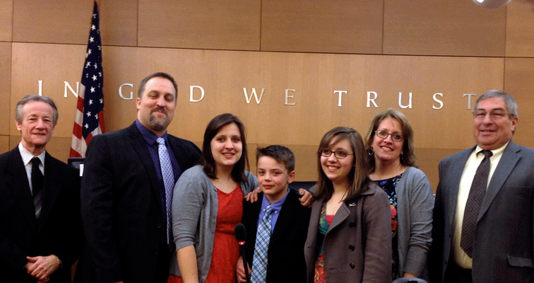 A family in court on their 10-year-old son's adoption day from foster care.