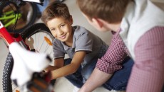 A boy with a bike, representing No Biking in the House without a Helmet