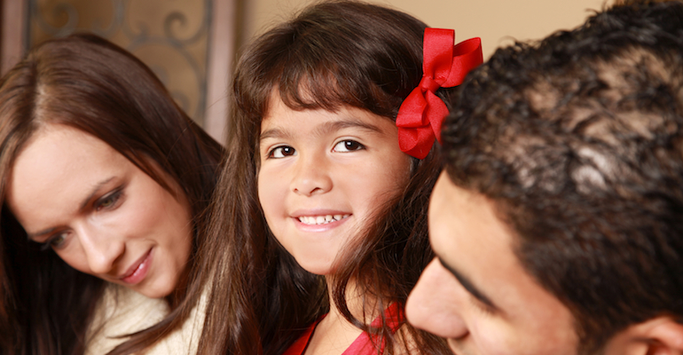 A happy child, whose parents used adoption parenting guides to help raise her