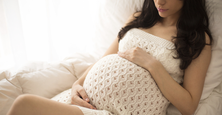 A pregnant woman, thinking about prenatal drug and alcohol use