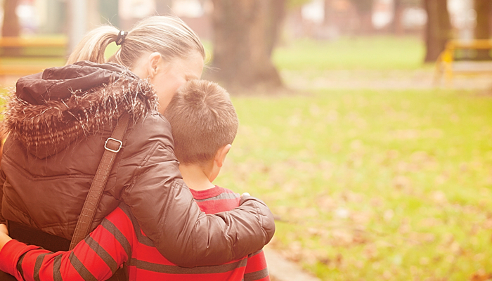 Adoptive mother and son walking and talking about the difficult details of his adoption story