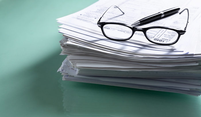 stack of forms you might need to claim the adoption tax credit