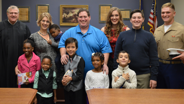 Julia Baxter with her family, including four new siblings through foster adoption, on their adoption day