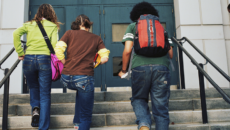 a transracially adopted teen heading into school with friends