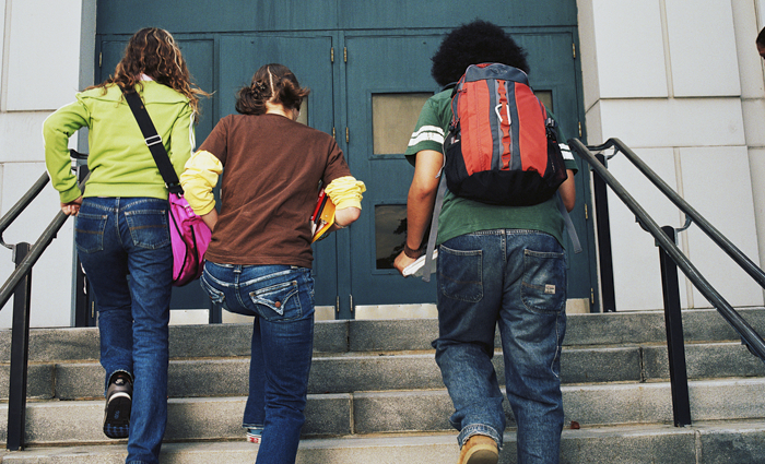 a transracially adopted teen heading into school with friends