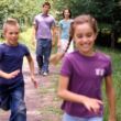 parents walking with their two children after deciding on a second adoption