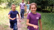 parents walking with their two children after deciding on a second adoption