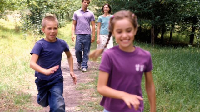 parents walking with their two children after deciding on a second adoption