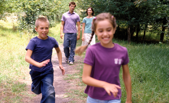 parents walking with their two children after deciding on a second adoption