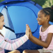 Two girls playing together and discussing racism at Pact Camp