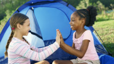 Two girls playing together and discussing racism at Pact Camp