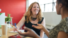 An adoptive mother talks with her child's teacher at school about adoption