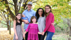 Author Lisa Emmerich and her husband with their three biological children and newborn son through domestic adoption