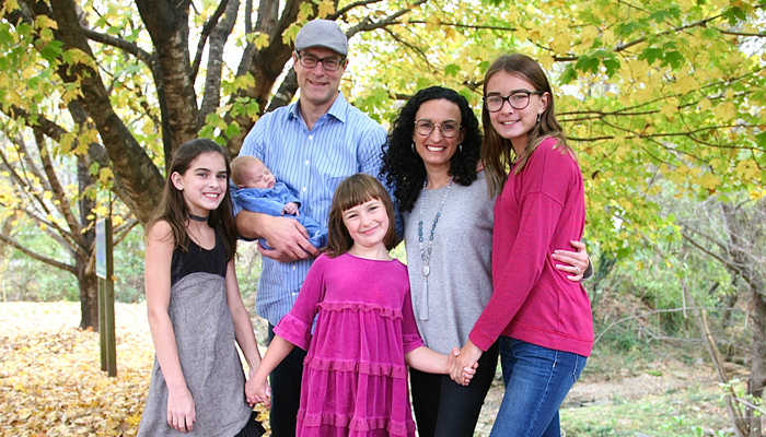 Author Lisa Emmerich and her husband with their three biological children and newborn son through domestic adoption