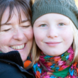 An adoptive mother hugs her preteen daughter after a good talk about adoption