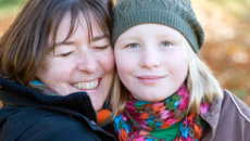 An adoptive mother hugs her preteen daughter after a good talk about adoption