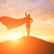 woman wearing a cape on a mountain, representing adoptive parents' "adoption heroes," including their child's birth mother or their social worker