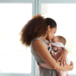 An adoptive mom cuddles with her newly adopted baby to promote bonding