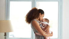 An adoptive mom cuddles with her newly adopted baby to promote bonding