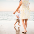 A mother plays with her son through foster adoption on the beach and shares the adoption story behind the photo