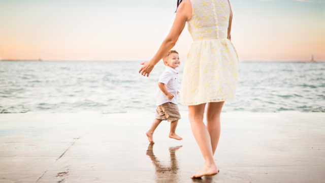 A mother plays with her son through foster adoption on the beach and shares the adoption story behind the photo