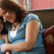 A grandmother and the granddaughter she adopted share a close moment