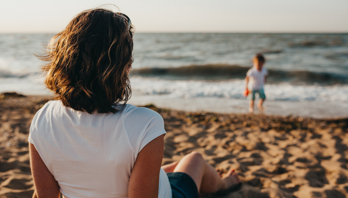 An adoptive mother watches her son at the beach and thinks about contact with his birth mother