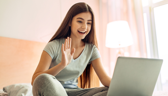 teenage girl video chatting with her birth sibling in another family